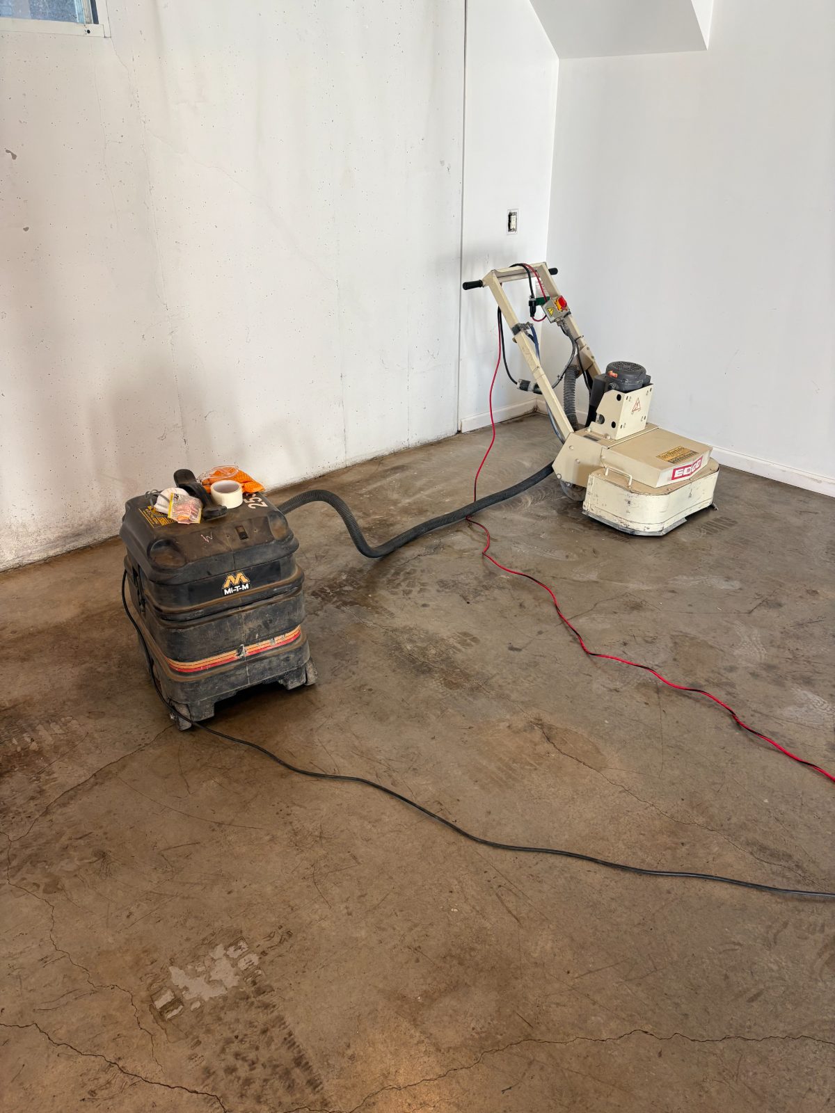 Floor grinder and dust extractor on site